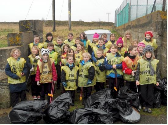 Photograph of Young litter pickers get busy sprucing up their village
